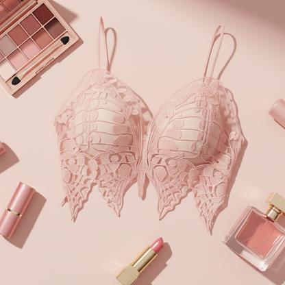 Pink lace bra with makeup and perfume on a pink background