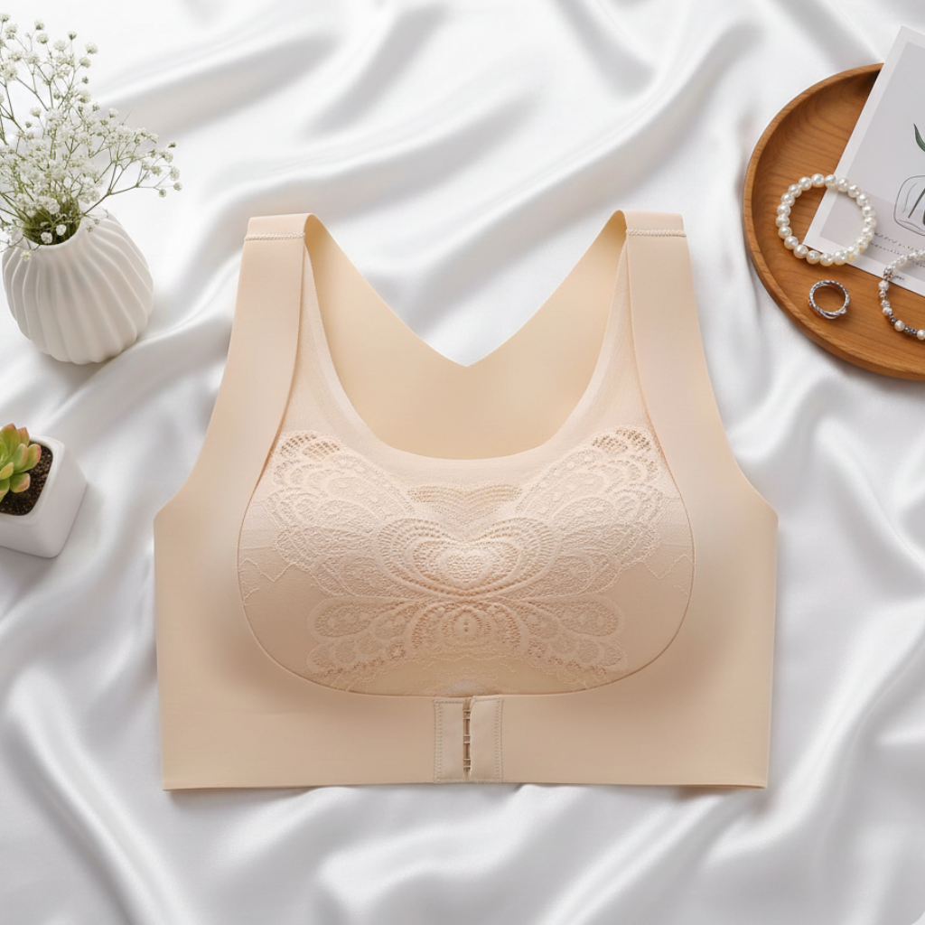 Beige bralette on a white fabric background with decorative items around
