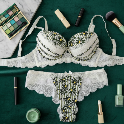 Patterned lingerie set with makeup items on a green surface