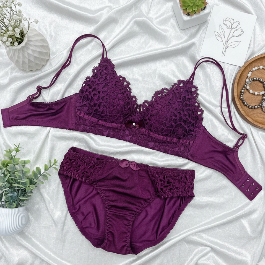 Purple lace lingerie set on a white fabric background with decorative elements.