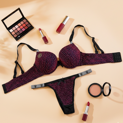 Purple lingerie set with makeup items on a beige background