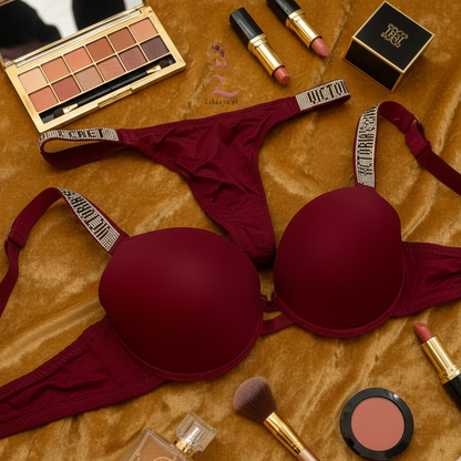 Red lingerie set with makeup and accessories on a textured surface
