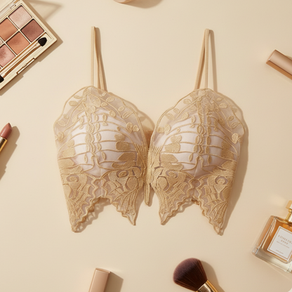 Lace bralette on a beige background with makeup and perfume bottles.