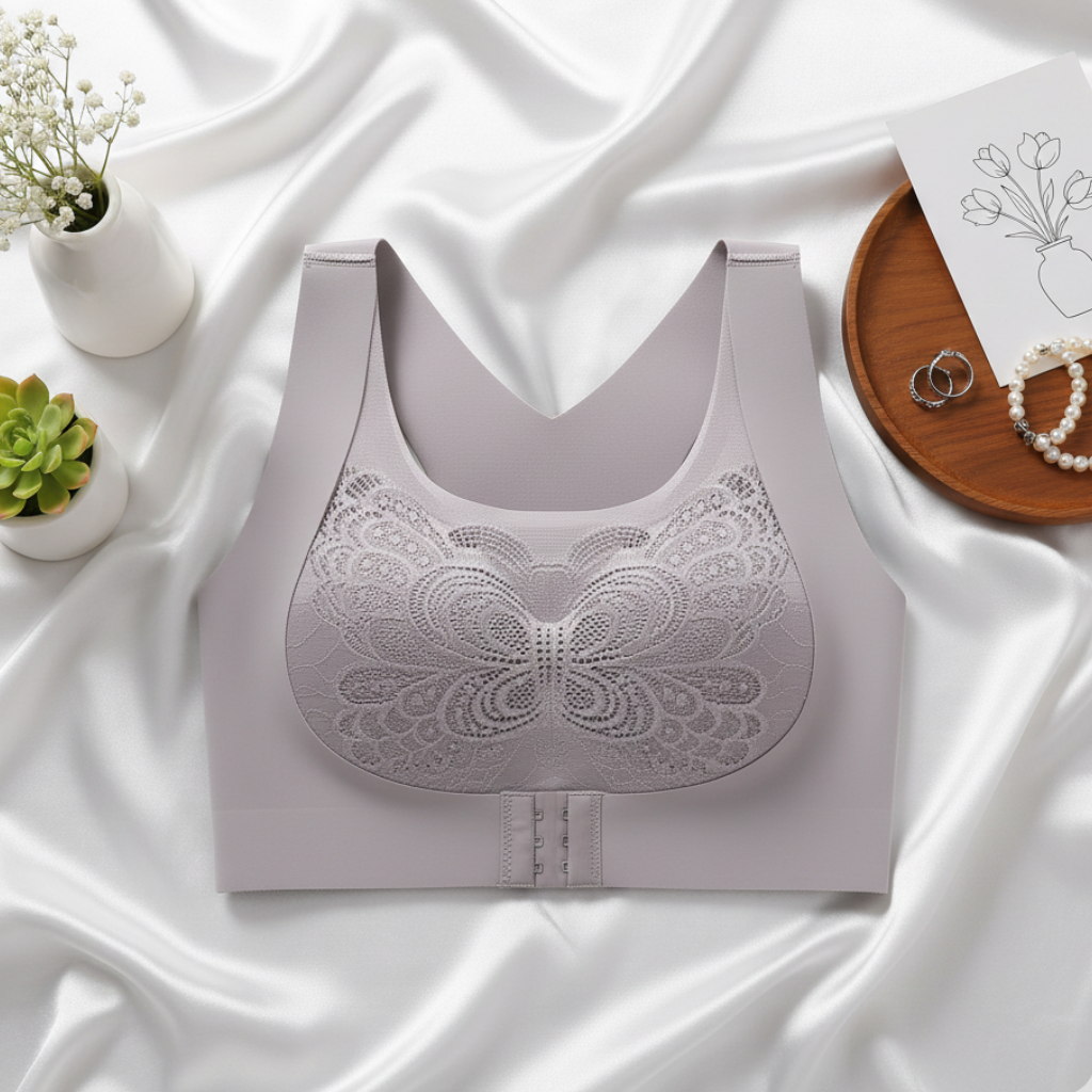 Light gray lace bralette on a white fabric background with decorative elements.