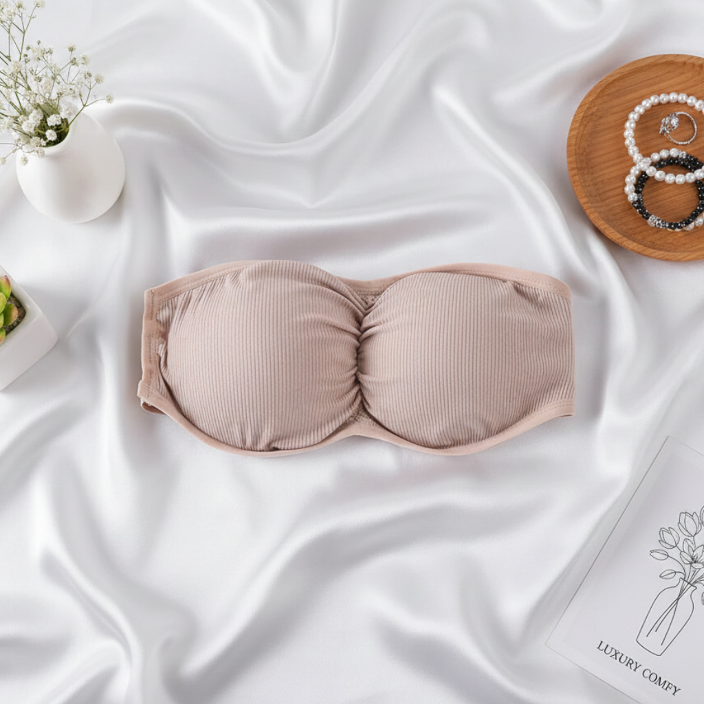 Beige ribbed bra on a white fabric background with decorative elements.