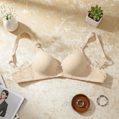 Beige bra on a textured surface with decorative items around