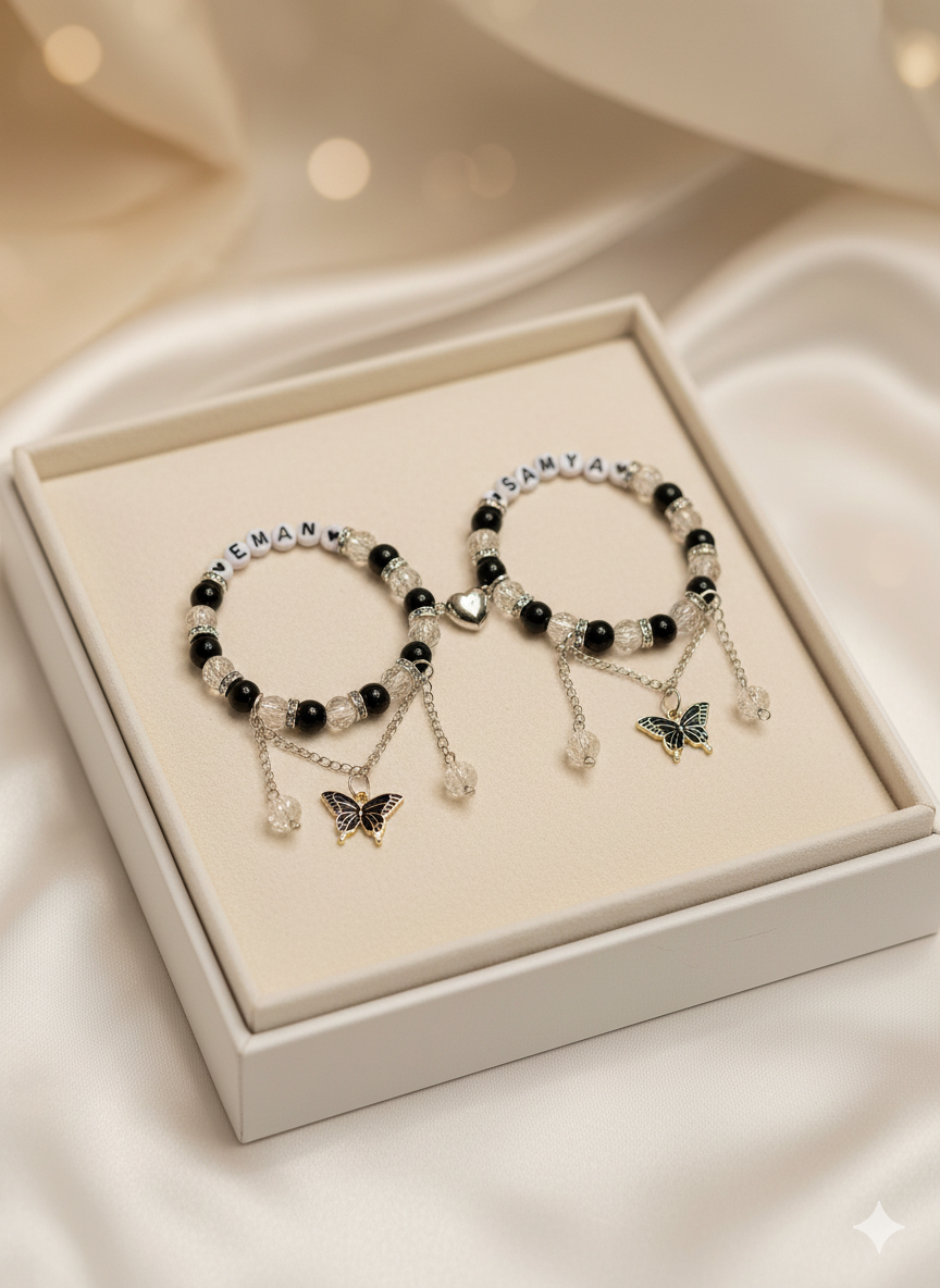 Pair of beaded bracelets with butterfly charms in a white box