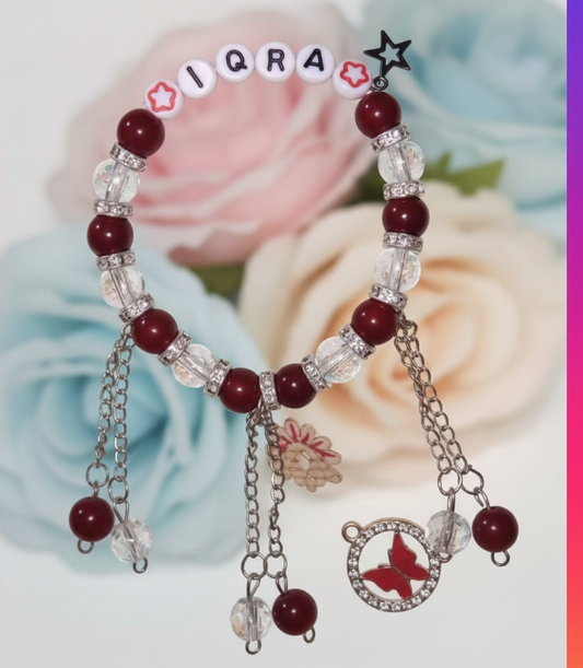 Bracelet with red beads and charms on a floral background